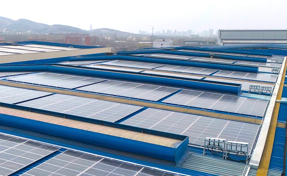 Aerial view over large industrial solar rooftops